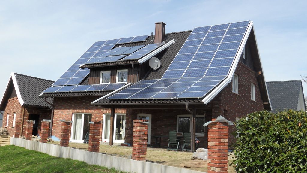 Brick family home with a full row of solar panels on its roof